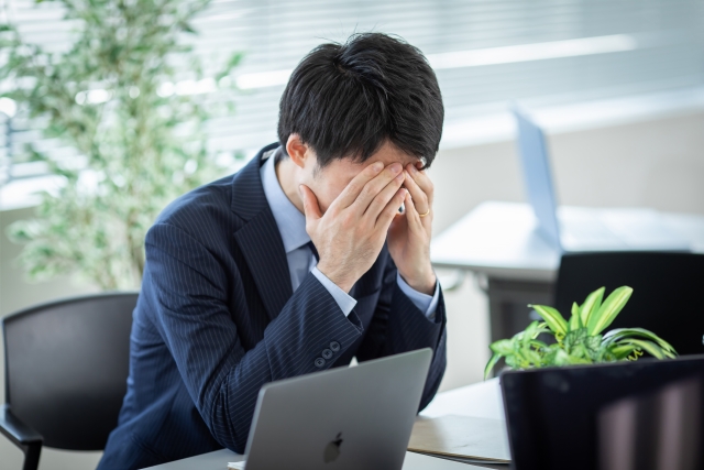 商談テーブルで困惑した表情の男性一人社長